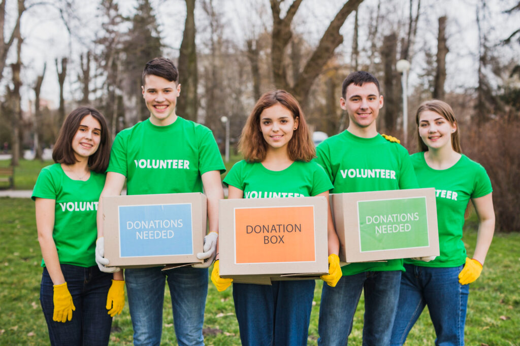 Young Volunteers holding boxes