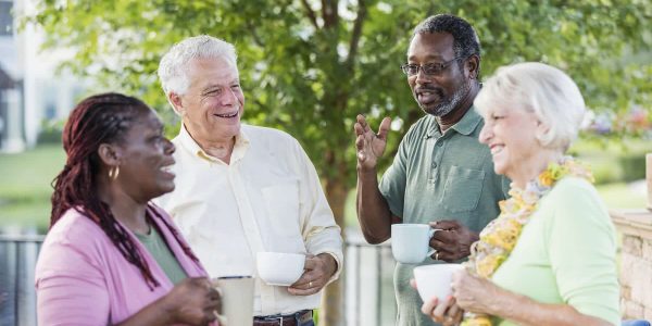 4 seniors talking and laughing